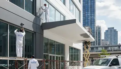 Professional commercial painters in Hartford CT applying durable exterior coatings to office building